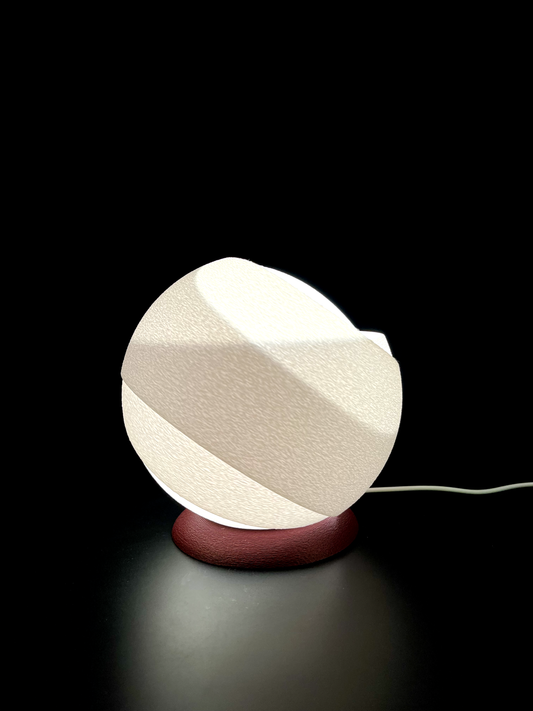 Modern table lamp with geometric design on a black background