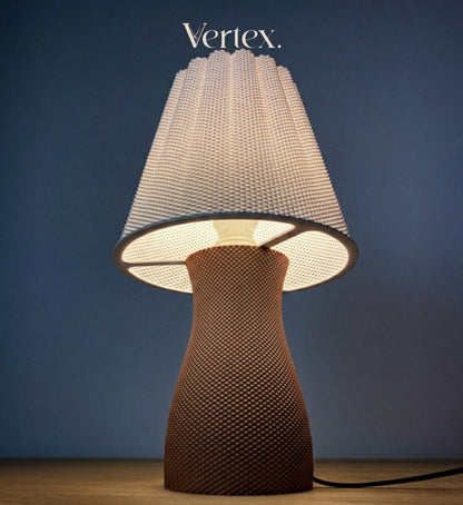 A table lamp with a textured, woven mushroom-shaped base in a warm brown tone and a matching textured white shade, shown lit against a dark blue background. The brand name 'Vertex.