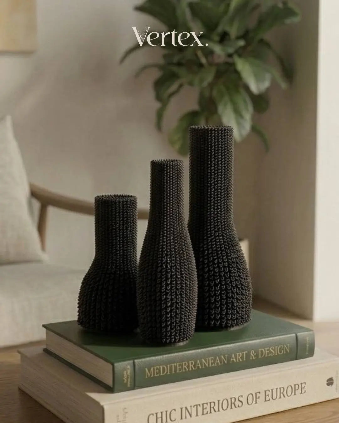 Three black textured vases on books with 'Vertex' branding in the corner.
