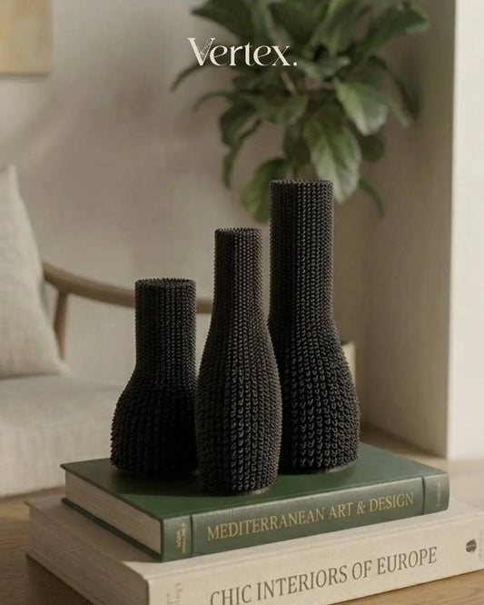 Three black textured vases on books with 'Vertex' branding in the corner.
