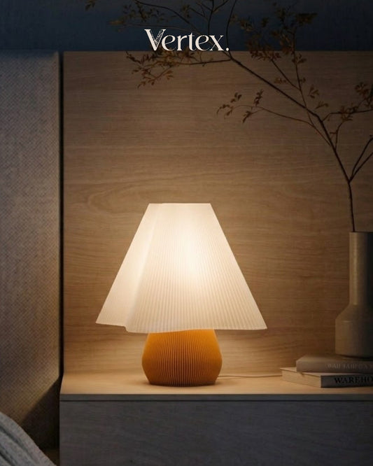 Table lamp with a ribbed design on a wooden surface, illuminated by 'Vertex' brand.