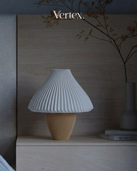 Table lamp with ribbed design on a wooden surface, featuring the brand 'Vertex'.