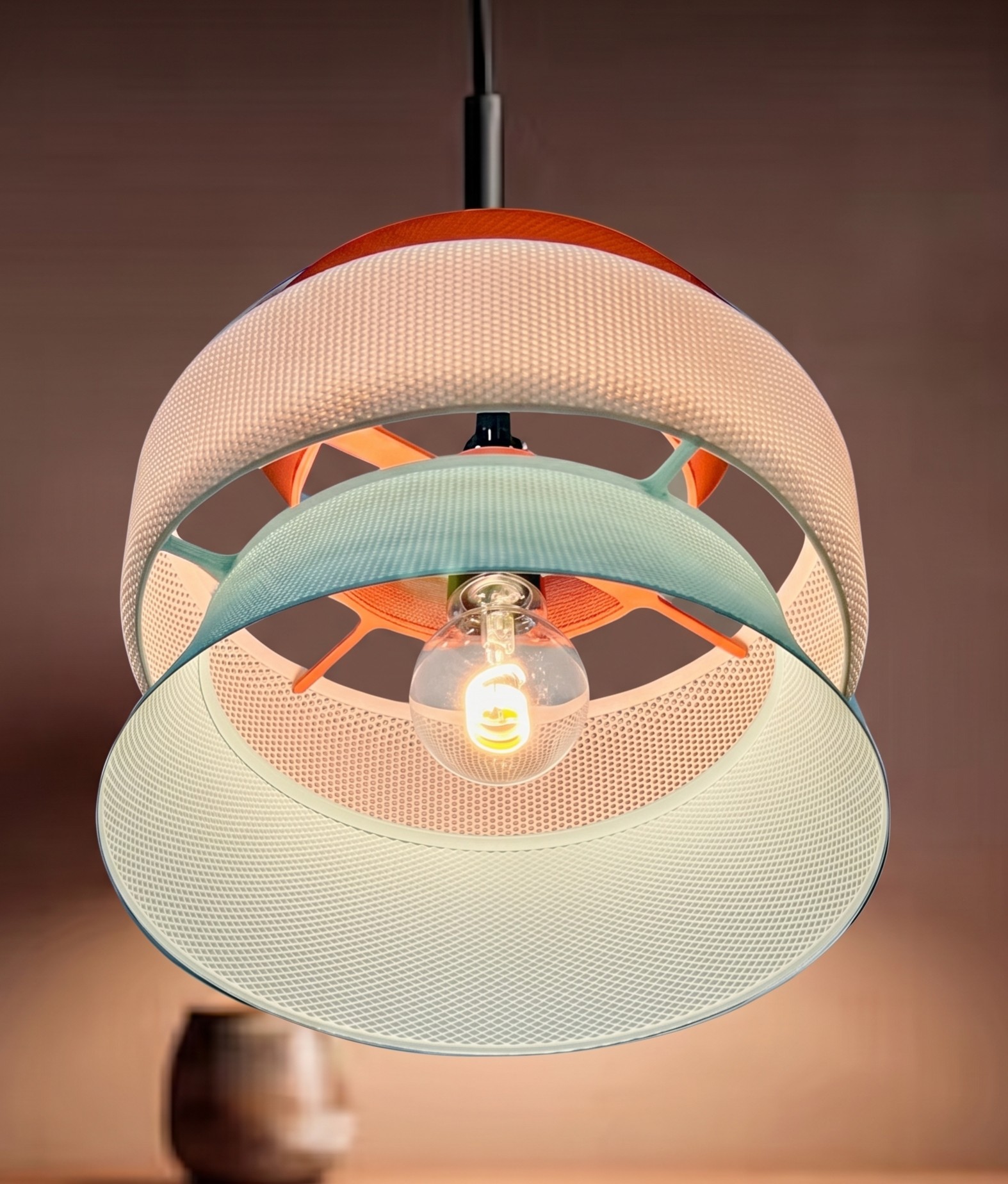 Modern pendant light with a textured design on a dark background