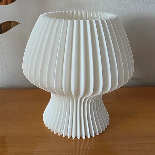Beige textured table lamp on a wooden surface with 'Vertex.' 