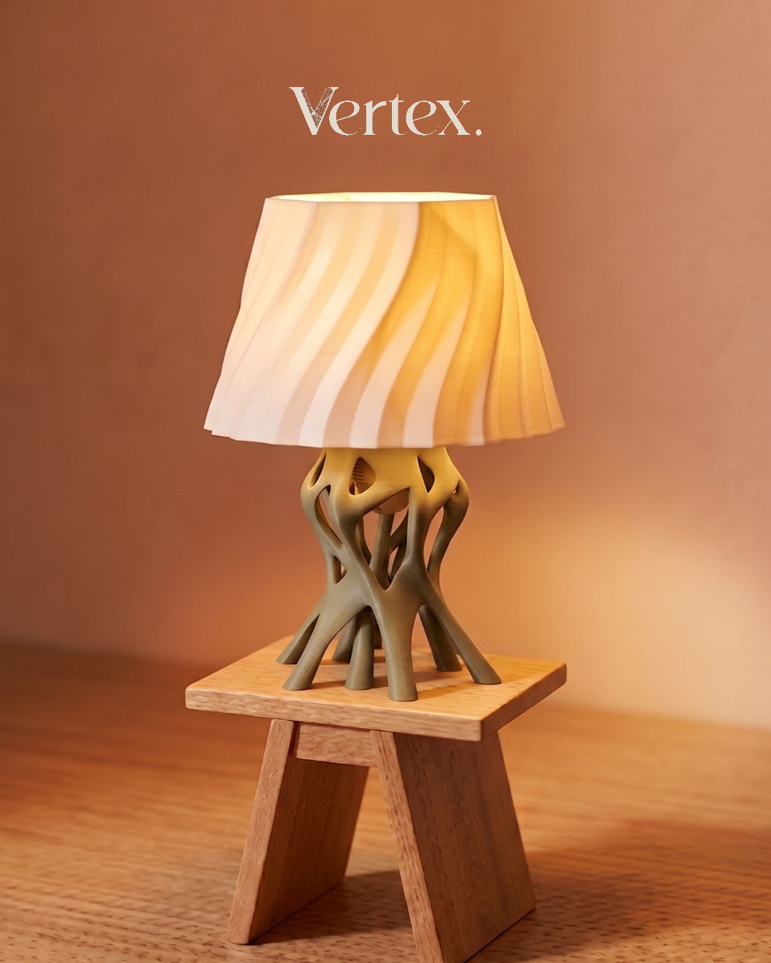 Table lamp with unique base design on a wooden stand against a warm brown background, featuring the brand 'Vertex'.